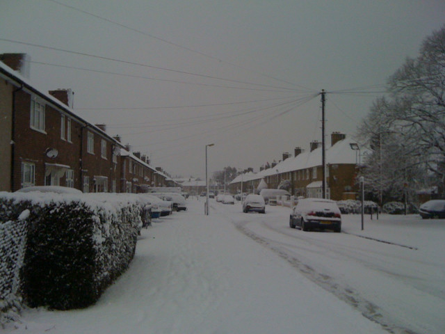 Snow lined streets of London. Townhomes line the streets.