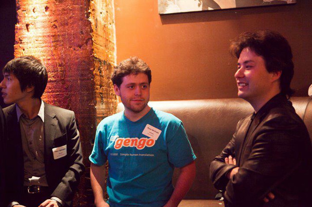 A man in a bright blue shirt at a developer conference.