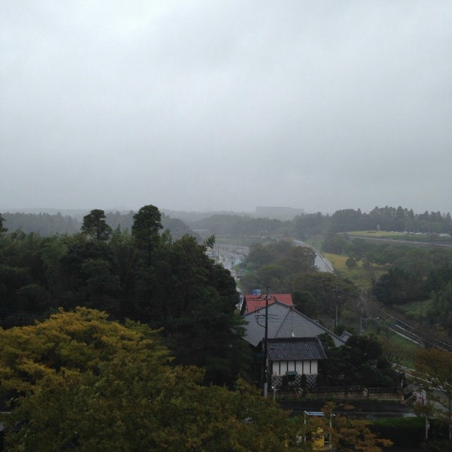 Looking out over the misty countryside of Japan. A small house is visible.