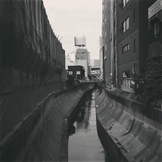 Staring down a canal. Construction off to the left, buildings off to the right.