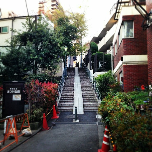 Curved stairs going up a pack of buildings.