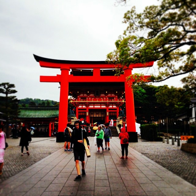 An incredibly large torii over the base area of a forest.