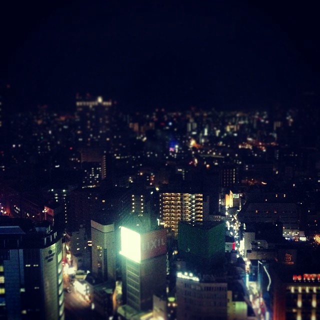 A dark and somewhat adjusted shot of the Osaka city skyline at night.