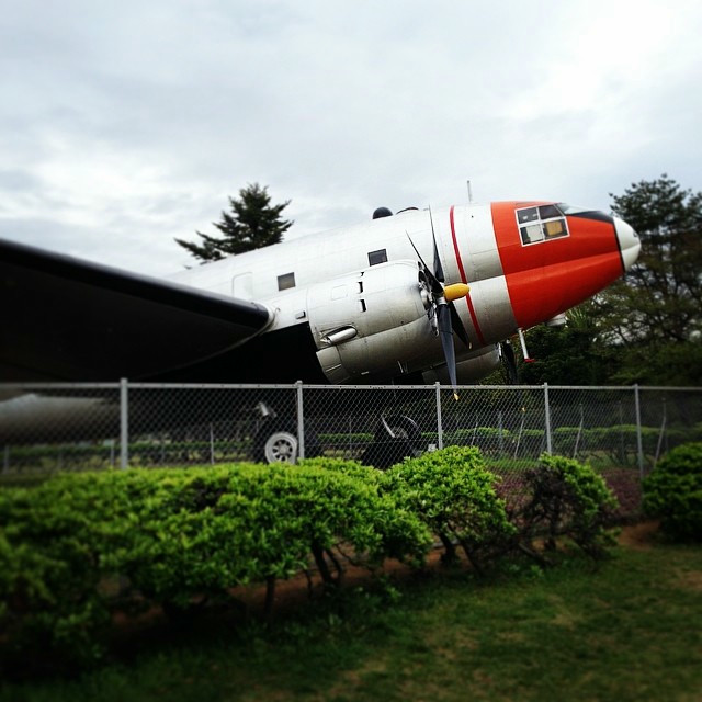 The nose of an airplane, pointed towards the sky.