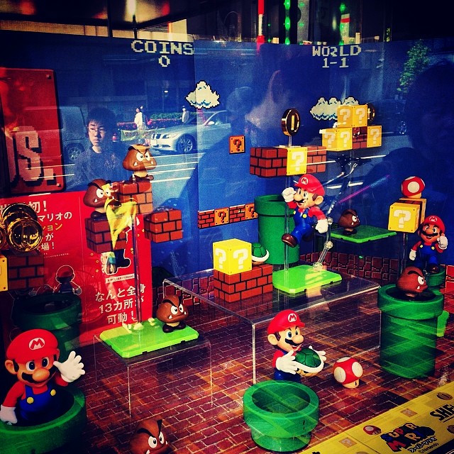 A department store display with Mario in various game-specific poses.