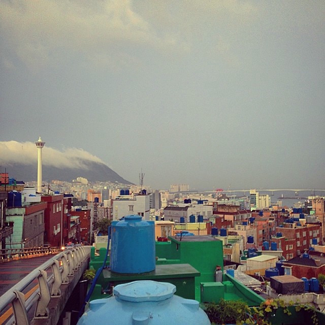 Busan city skyline. A mountain with fog rolling in the distance.