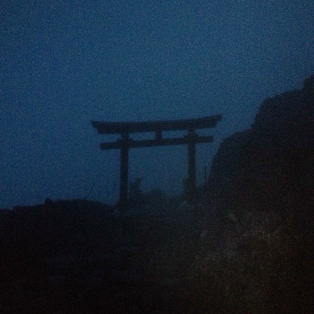 A lone Japanese torii gate guarding the top of Mt. Fuji.