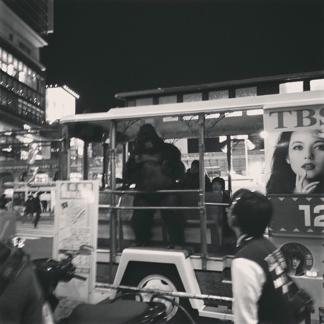 A man in a gorilla suit dances atop a bus in Shibuya