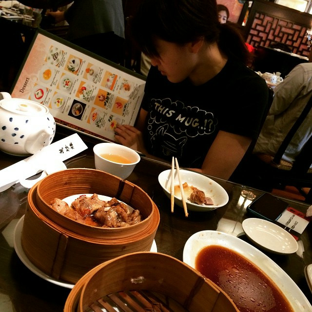 A woman browsing the menu in a Chinese restaurant.