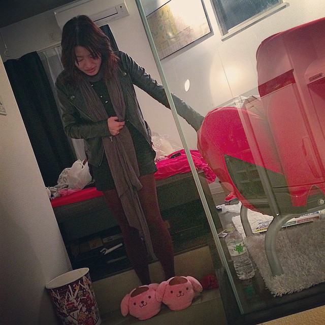 A woman on a set of stairs with some cute pink slippers.