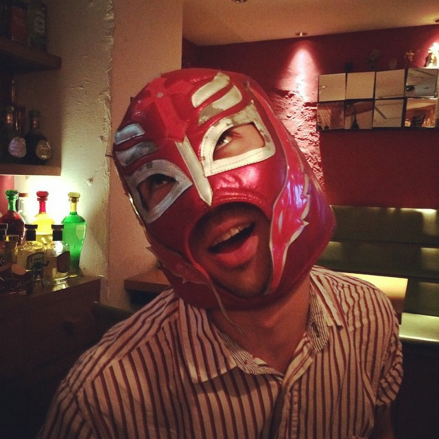 A drunk man in a red luchador mask.