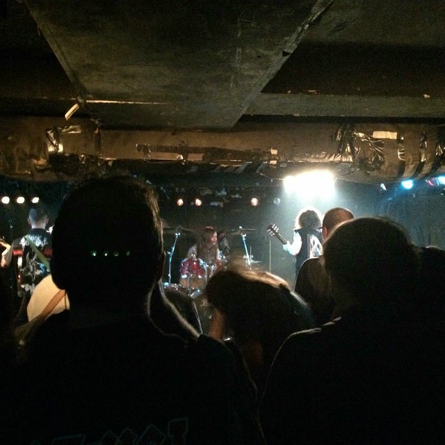 A crowded underground venue. The band is barely visible.