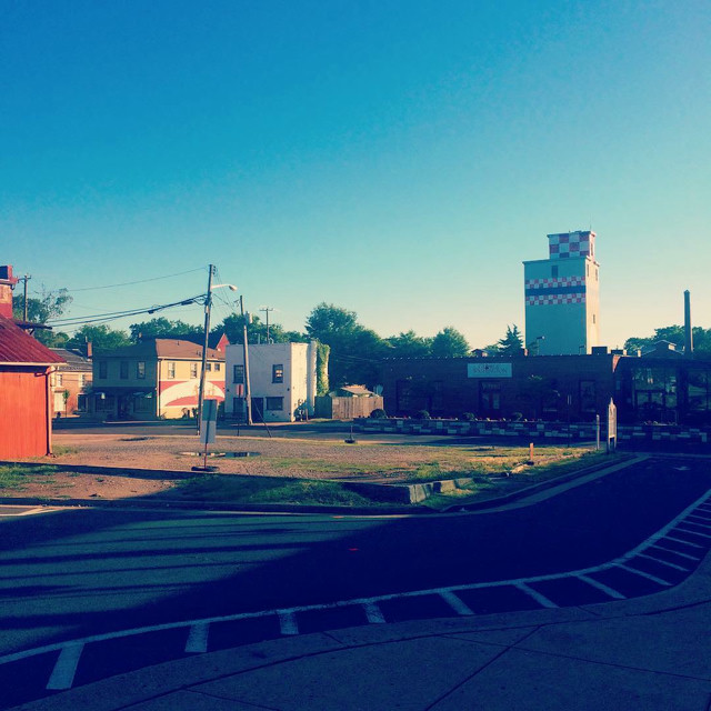 Buildings surrounding the road entrance to a train station.