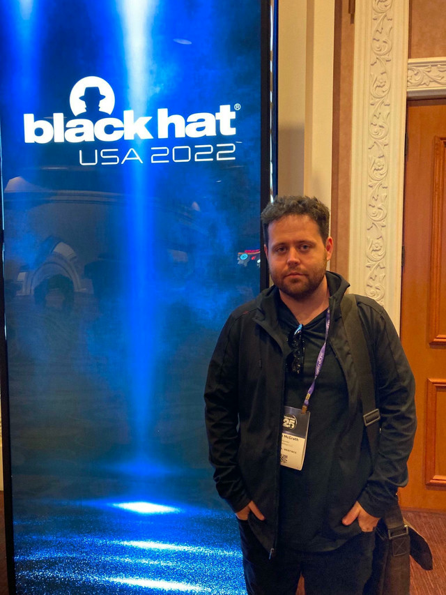 Me posing near the entrance sign for Black Hat 2022.