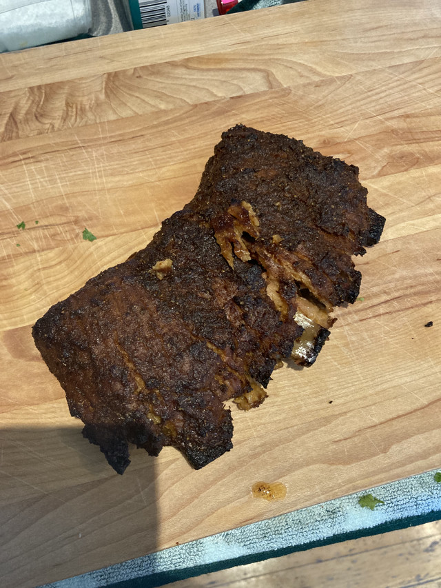 A charred BBQ rack of short vegan ribs.