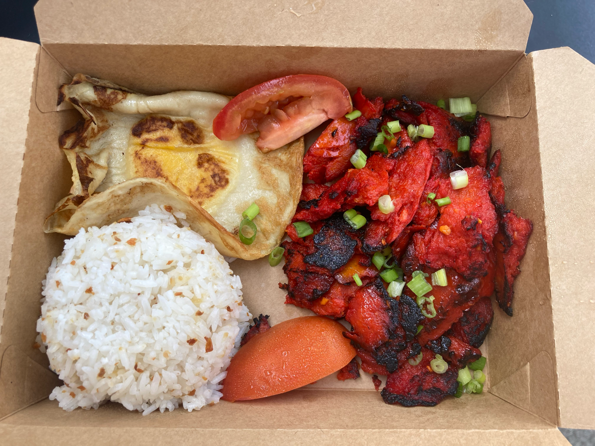 A box of tocilog. White rice, a mock fried egg, and bright red tocino chunks.