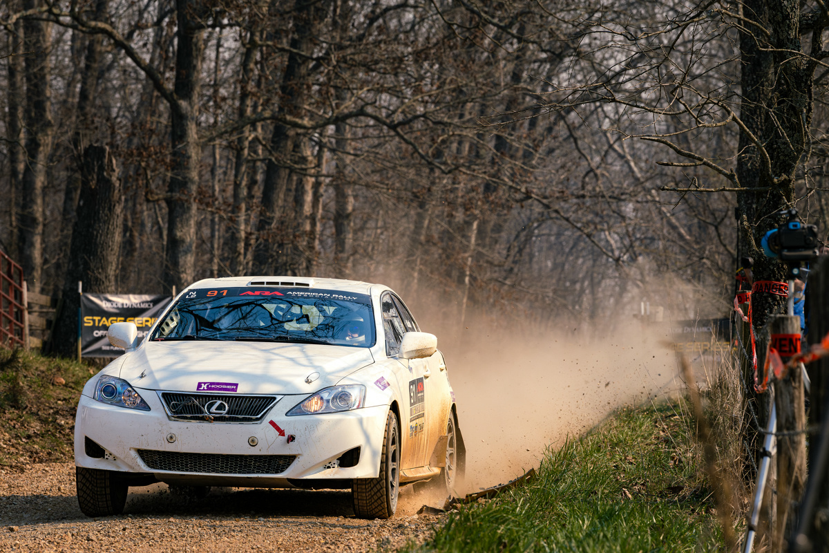 A white Lexus IS250 accelerates after landing from a jump.