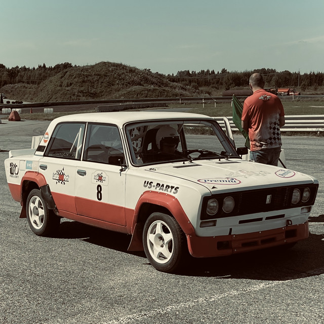 Me sitting in an old Lada rally car at the start line of a track, undergoing some final checks.