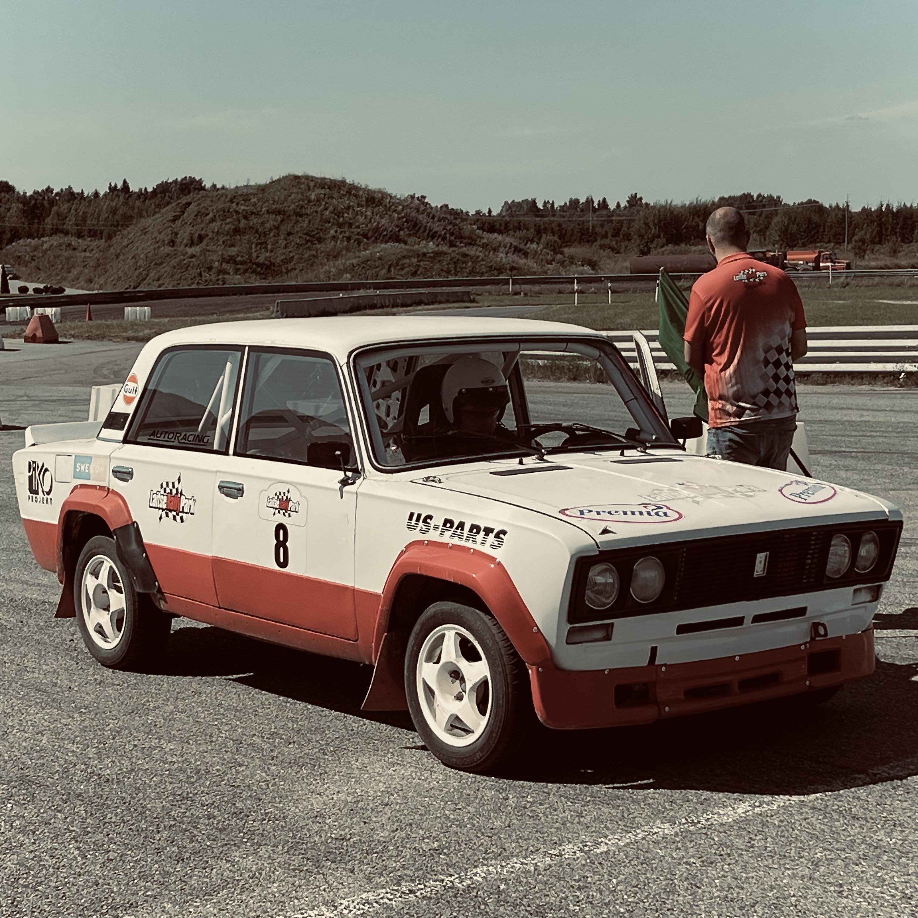 Me sitting in an old Lada rally car at the start line of a track, undergoing some final checks.